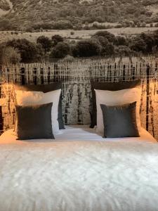 a bedroom with a large bed with pillows at Le Sens Six in Montpellier