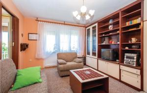 a living room with a couch and a chair at Beautiful Apartment In Crikvenica With 2 Bedrooms And Wifi in Crikvenica