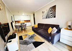 - un salon avec un canapé et une salle à manger dans l'établissement Apartamenty Sun&Fun Royal, à Karpacz