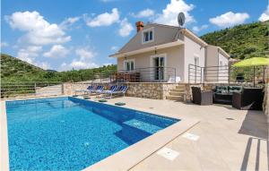 a villa with a swimming pool and a house at Lovely Home In Zaton With Private Swimming Pool, Can Be Inside Or Outside in Zaton