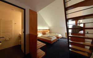 a hotel room with two beds and a bathroom at Hotel Gasthof Groß in Bergkirchen