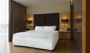 Postel nebo postele na pokoji v ubytování Empire Hotel Subang