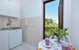 a small kitchen with a table and a window at Beautiful Apartment In Vrboska With Kitchenette in Vrboska