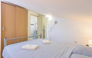 a bedroom with a bed with two towels on it at Amazing Apartment In Medulin With Wifi in Medulin