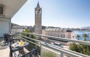 a balcony with a table and a clock tower at Two-Bedroom Apartment In Ploce in Ploče +25 photos