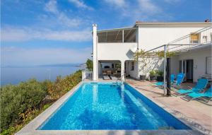 een villa met een zwembad en de oceaan bij Stunning Apartment In Sv,juraj With Heated Swimming Pool in Sveti Juraj