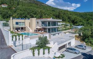 an aerial view of a house with a swimming pool at Cozy Apartment In Plomin With Kitchen in Plomin