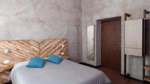 a bedroom with a bed with two blue pillows at Folia in Rome