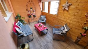 an overhead view of a porch with chairs and a table at Appartement duplex climatisé avec terrasse "HANSI" in Colmar