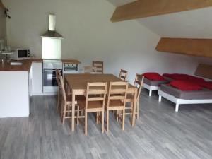 a kitchen and dining room with a table and chairs at Gite du Domaine du Mas du Taillet in Lanarce