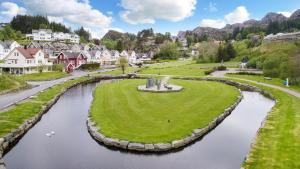 a small town with a river in the middle at Bergen/Sotra:Waterfront cabin(s).Boat.Fish.Jacuzzi in Haganes