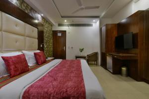 Postel nebo postele na pokoji v ubytování Hotel Yuvraj Deluxe