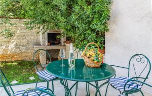 a table with a basket of food and two wine glasses at Beautiful Apartment In Pula With 3 Bedrooms And Wifi in Pula