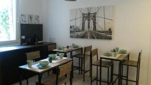 a dining room with tables and chairs and a picture of a bridge at SoleLuna Fiera 6 Rooms in Bologna