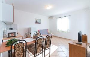 a kitchen and living room with a table and chairs at Amazing Apartment In Vidalici With Wifi in Kustići