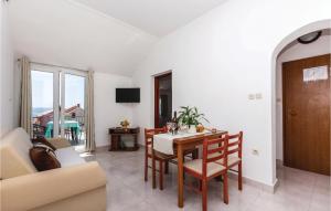 a living room with a table and chairs and a couch at Cozy Apartment In Crikvenica With Wifi in Crikvenica