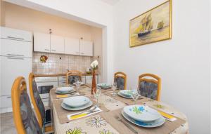 a kitchen with a wooden table with plates and dishes on it at Lovely Apartment In Lukovo Sugarje With Kitchen in Lukovo Šugarje