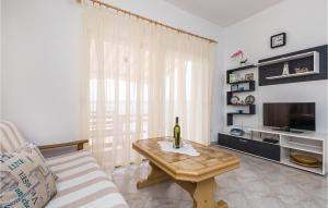 a living room with a bottle of wine on a table at Lovely Apartment In Lukovo Sugarje With Kitchen in Lukovo Šugarje