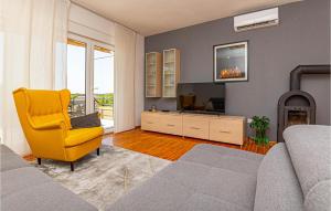 salon z żółtym krzesłem i telewizorem w obiekcie Lovely Home In Drnis With Wifi w mieście Drniš