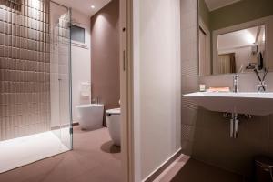 a bathroom with a toilet and a sink and a shower at La Corte del Fante in Marsala +45 photos