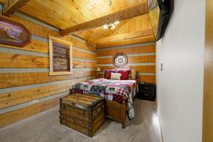 a bedroom with a bed in a log cabin at The Robins Nest with hot tub in Pigeon Forge