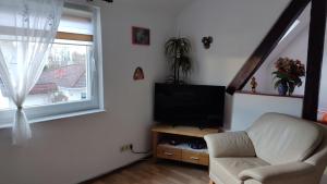 a living room with a couch and a television at Ferienwohnung in Rathenow Süd in Rathenow