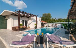 a pool with chairs and a table and a house at Lovely Home In Neoric With Kitchen in Neorić