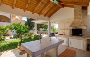 a kitchen with a table and a fireplace at Nice Apartment In Garica With Kitchen in Garica