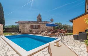 a villa with a swimming pool and a house at Gorgeous Apartment In Visnjan With Wifi in Višnjan