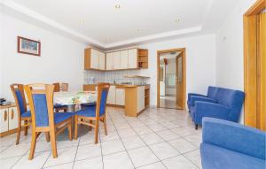 a kitchen and dining room with a table and chairs at Lovely Apartment In Grizane With Wifi in Kostelj