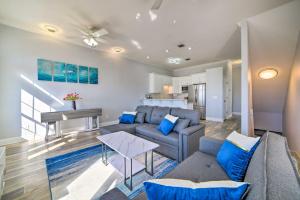 a living room with a couch and a table at Sunny PCB Home with Balcony Steps to the Beach! in Panama City Beach