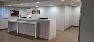 a lobby with a reception counter in a building at Clarion Pointe OKC Airport in Oklahoma City +72 photos