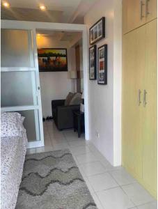 a living room with a bed and a couch at Tagaytay Prime Residence -Cityland in Tagaytay