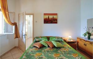 a bedroom with a bed with pillows on it at Pet Friendly Home In Trget With House Sea View in Trget