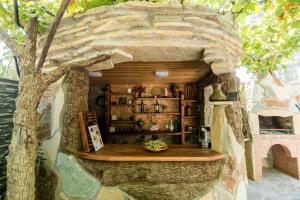 a stone building with a counter in a tree at The oldest Tbilisi in Tbilisi City