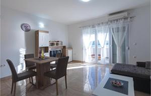 a living room with a table and chairs and a couch at Nice Apartment In Klek With House Sea View in Klek