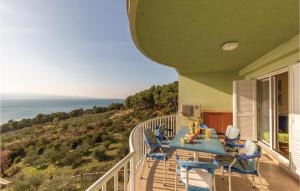 a balcony with a table and chairs and the ocean at Stunning Apartment In Brela With Wifi in Brela