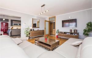 a living room with a white couch and a table at Nice Apartment In Rijeka With Wifi in Rijeka