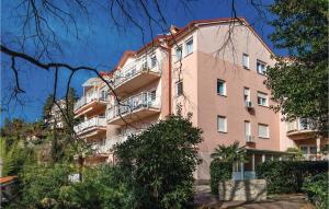 a pink building with balconies on a hill at Nice Apartment In Rijeka With Wifi in Rijeka