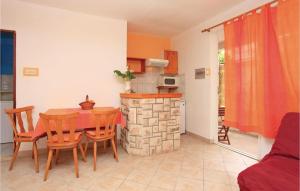 a kitchen and dining room with a table and a fireplace at Lovely Apartment In Vela Luka With Kitchen in Vela Luka