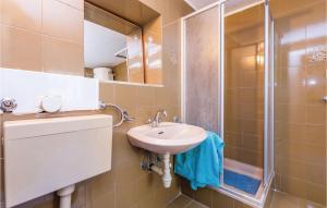 a bathroom with a sink and a shower at Stunning Apartment In Senj With Wifi in Senj