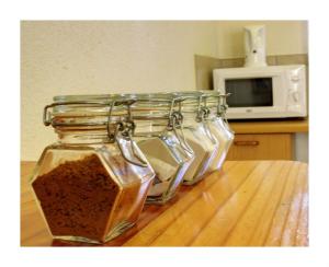 a group of four glass jars sitting on top of a table at Alte Welkom Guesthouse in Klerksdorp