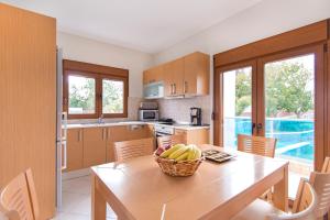 a kitchen with a table with a basket of bananas on it at Horizon Line Villas in Kiotari +22 photos