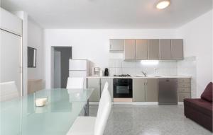 a kitchen with a glass table in a room at Nice Apartment In Stinjan With Kitchen in Štinjan