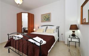 a bedroom with a bed and a table with a lamp at Beautiful Apartment In Pirovac With Wifi in Pirovac