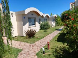 a house with a pathway in front of it at Cabañas Elabu in San Miguel del Monte