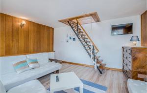 a living room with a white couch and a staircase at 2 Bedroom Gorgeous Home In Baska in Baška
