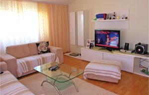 a living room with a couch and a tv at 3 Bedroom Beautiful Apartment In Kastel Novi in Kastel Novi