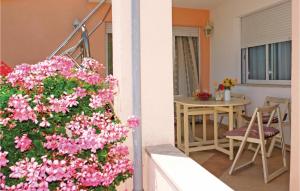 a balcony with pink flowers in a house at Amazing Apartment In Kastel Novi With 3 Bedrooms And Wifi in Kastel Novi