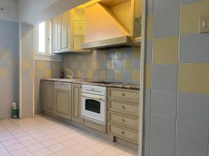 a kitchen with a stove and a sink and cabinets at Foresteria Sociale San Marco Venice in Venice